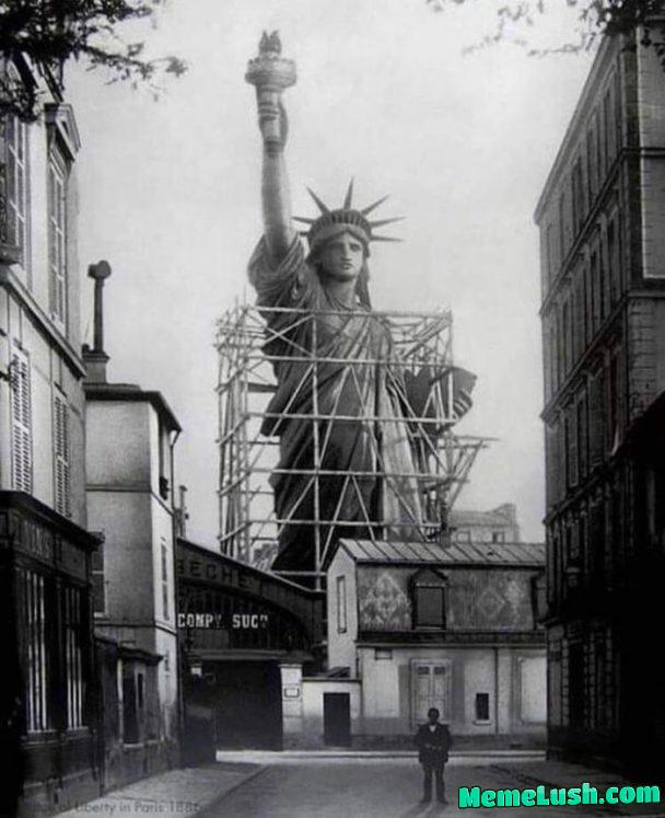 A historical photo of the Statue of Liberty being disassembled in France to be shipped to USA… and Jeff from accounting in a raincoat.