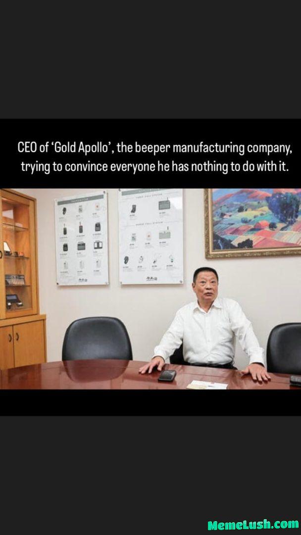CEO of Taiwanese beeper manufacturing company puts a serious face while trying to disassociate with mysterious 💥 (original image)